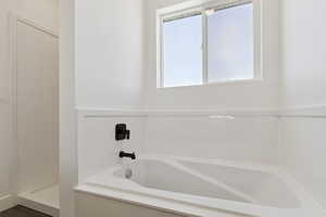 Full bath featuring a bath