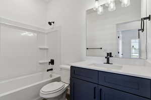 Bathroom featuring vanity and washtub / shower combination