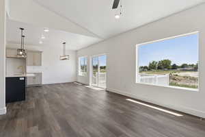 Unfurnished living room with vaulted ceiling, recessed lighting, a ceiling fan, and dark wood-style flooring
