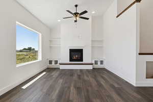 Unfurnished living room featuring a fireplace, ceiling fan, dark wood-style flooring, vaulted ceiling, and recessed lighting
