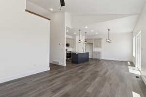Unfurnished living room with dark wood-style floors, lofted ceiling, recessed lighting, and a ceiling fan