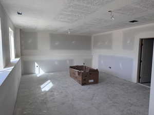 Empty room with a textured ceiling