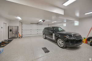 Garage featuring stainless steel fridge with ice dispenser