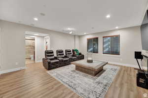 Living room with light wood-style flooring and recessed lighting
