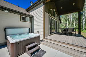 Wooden deck featuring a hot tub
