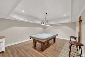 Rec room featuring a raised ceiling, pool table, recessed lighting, and light wood finished floors