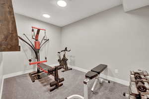 Workout area featuring baseboards and carpet flooring