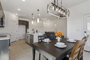 Dining room featuring light wood-style floors and hanging lights
