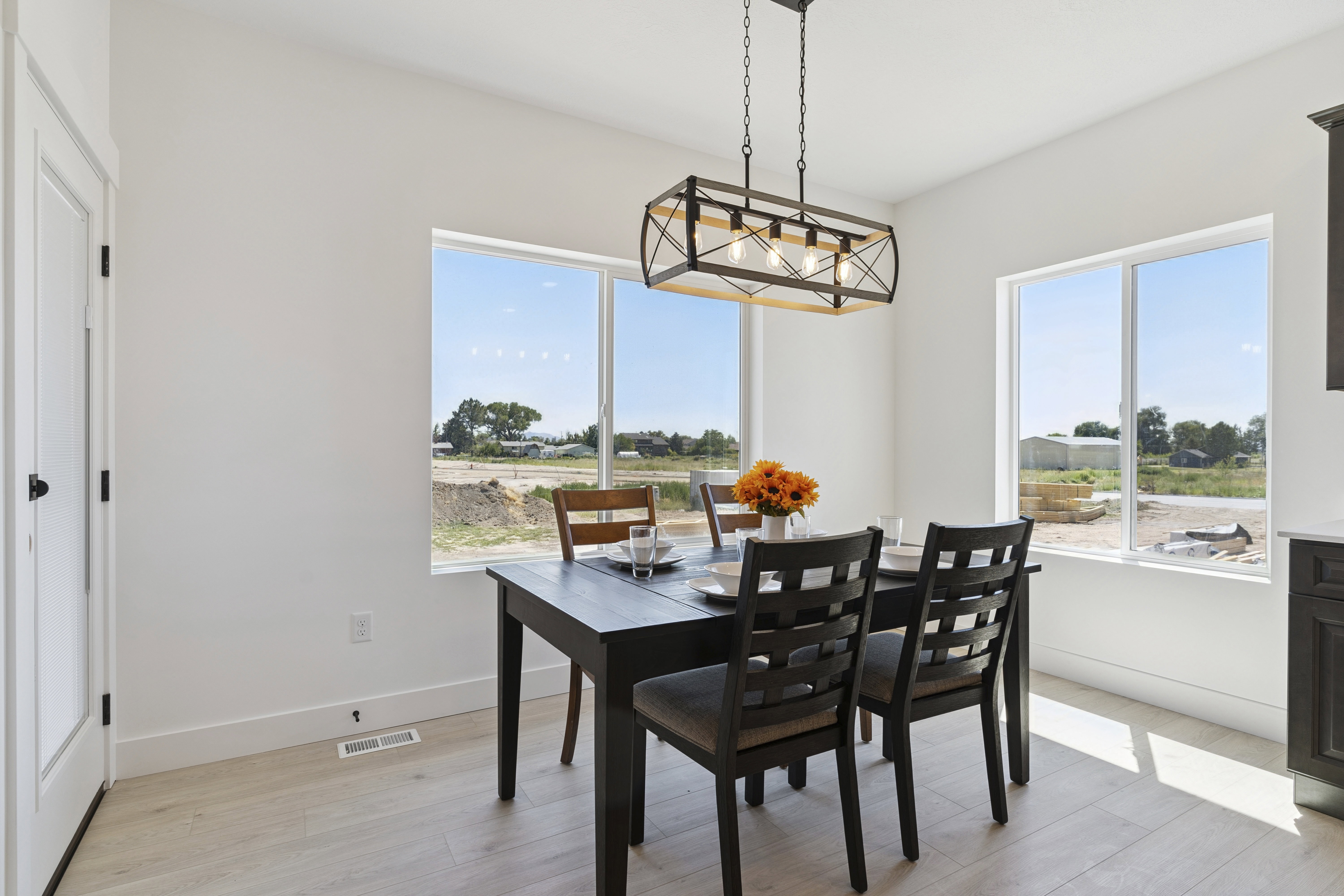 Dining space with light wood finished floors and plenty of natural light
