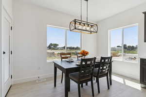Dining space with light wood finished floors and plenty of natural light