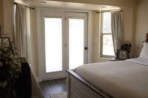 Master bedroom featuring wood-style floors and access to outside