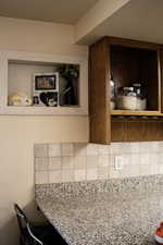 Kitchen view of decorative backsplash and shelving