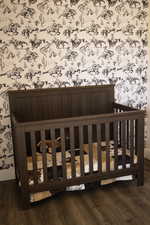 Nursery room with wallpapered wall