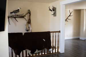 Stairway featuring wood finished floors and baseboards
