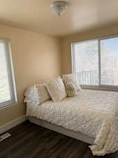 Bedroom featuring wood-style flooring and baseboards