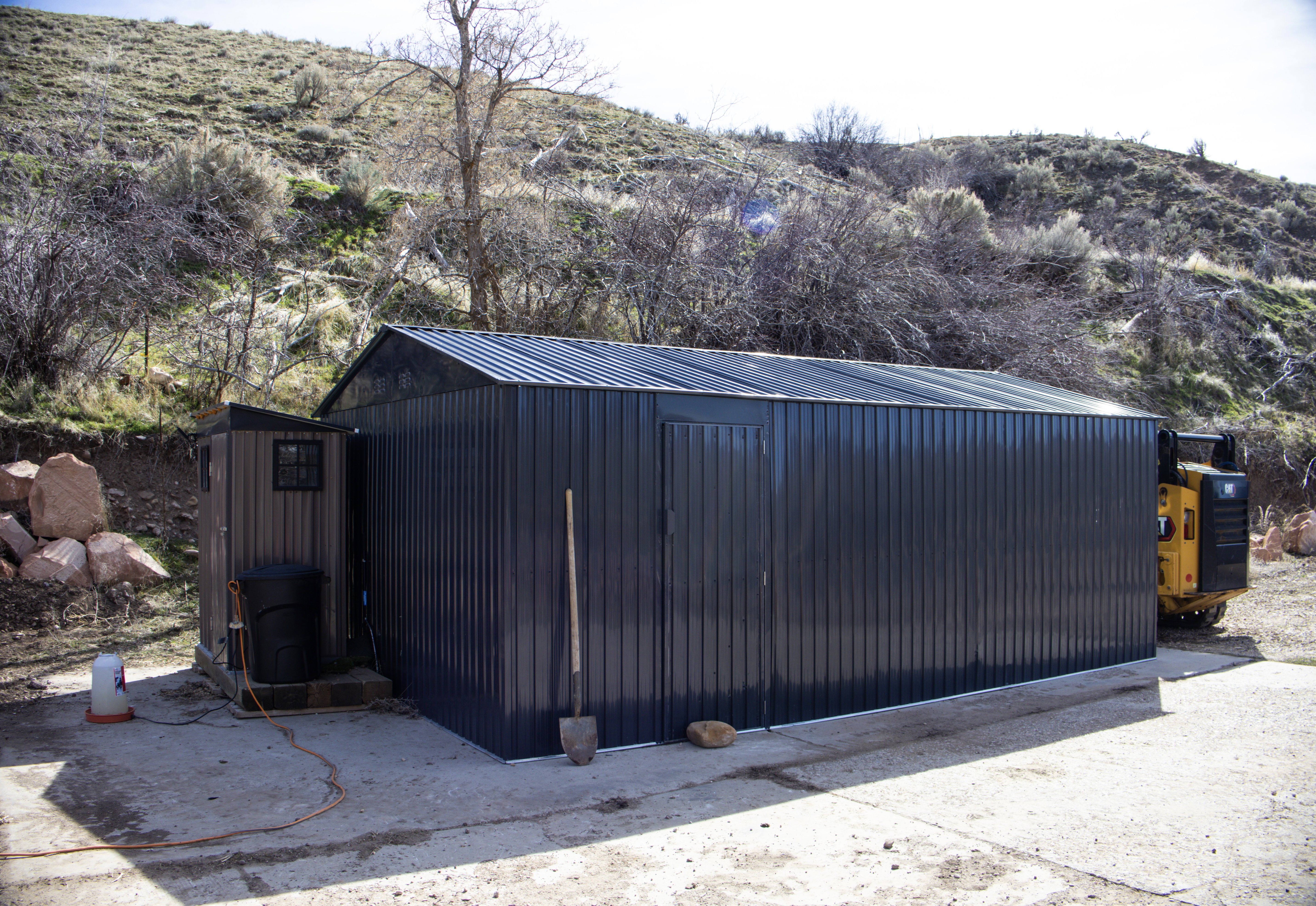 View of chicken coop and shed with a mountain view