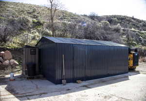 View of chicken coop and shed with a mountain view