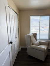 Nursery room with wood-style flooring and a textured ceiling