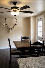 Dining area featuring wood-style floors and ceiling fan