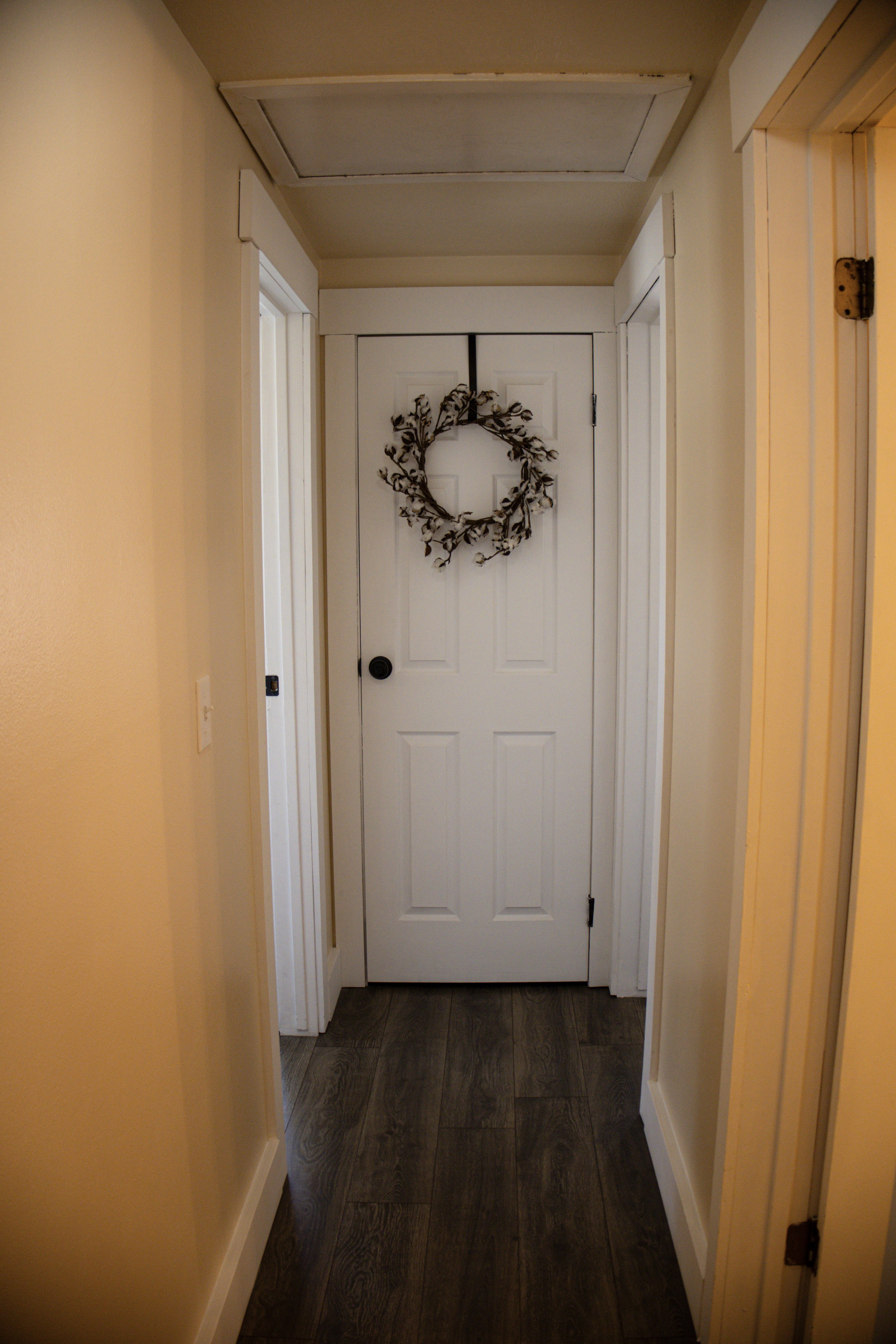 Hall with wood-style flooring and baseboards