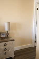 Detailed view of wood finished floors and baseboards in master bedroom