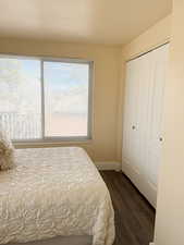 Bedroom with wood-style flooring and a closet