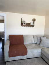 Living area featuring a textured ceiling and wood finished floors
