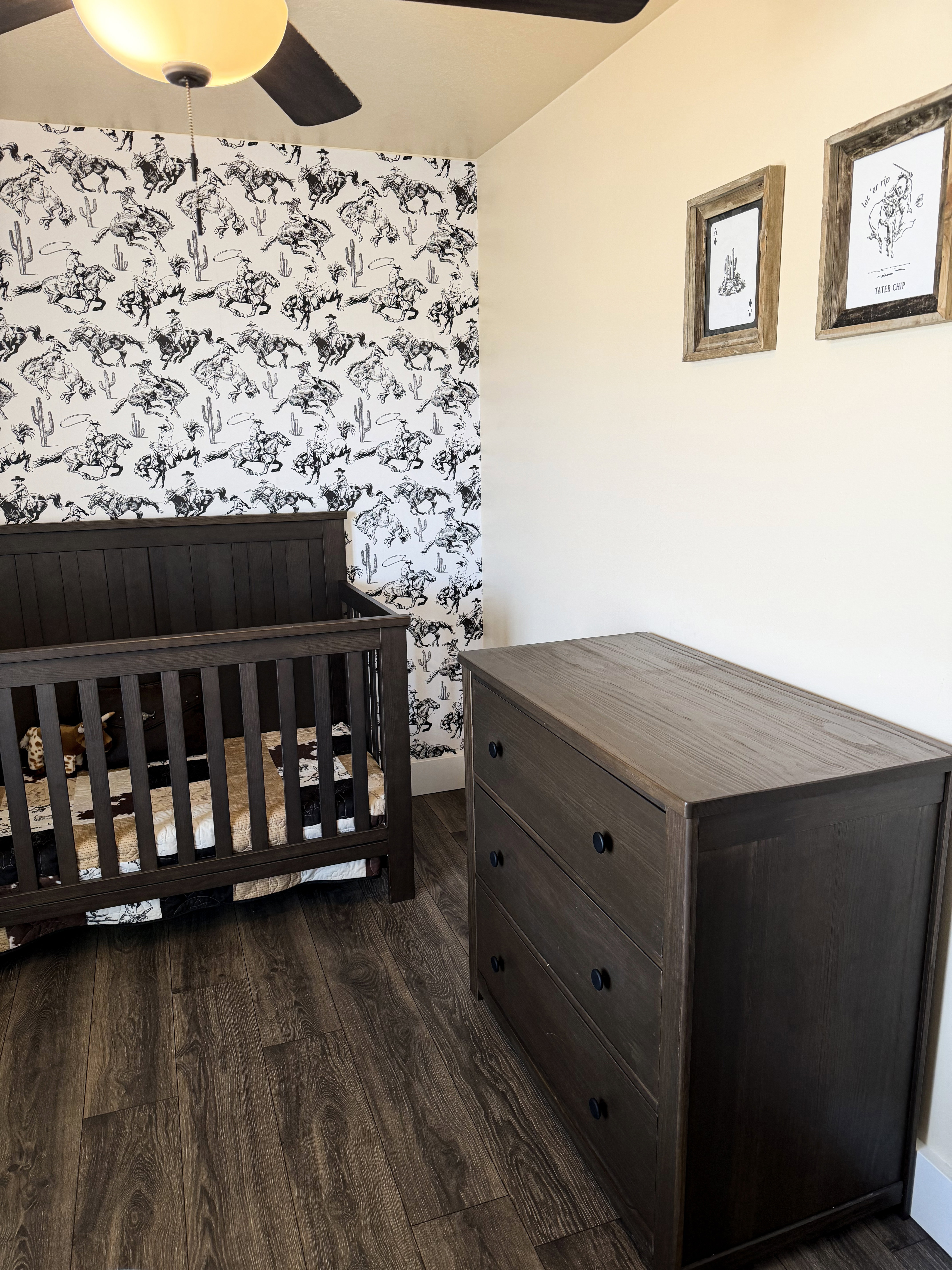 Bedroom featuring wood-style flooring, wallpapered wall, and ceiling fan