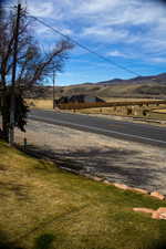 View of parking and asphalt street with a mountain view