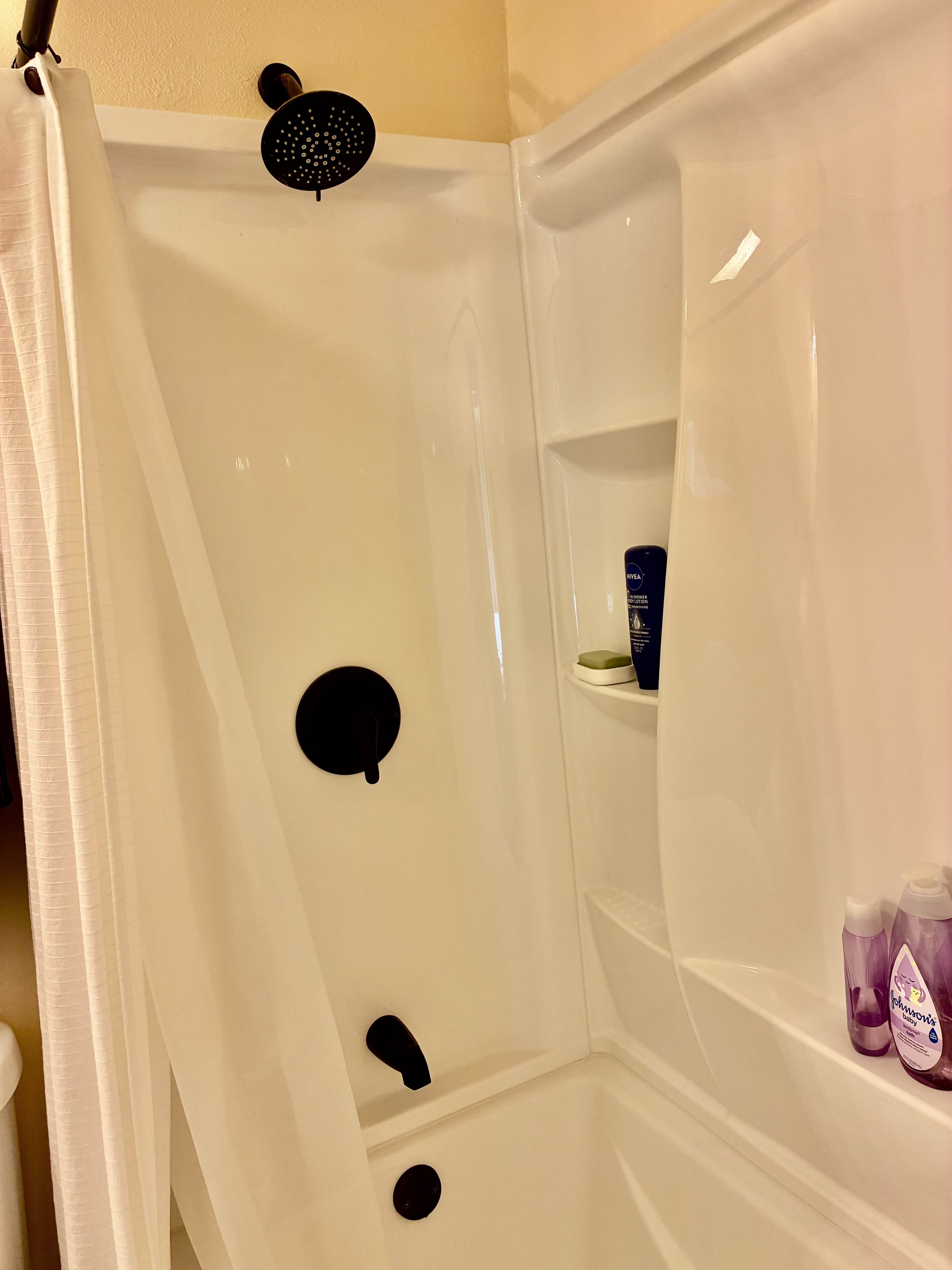 Full bathroom with curtained shower