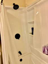 Full bathroom with curtained shower