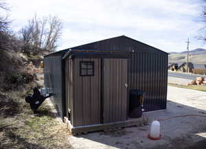 View of chicken coop with a mountain view
