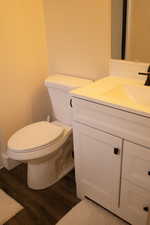 Master bathroom with vanity and wood finished floors