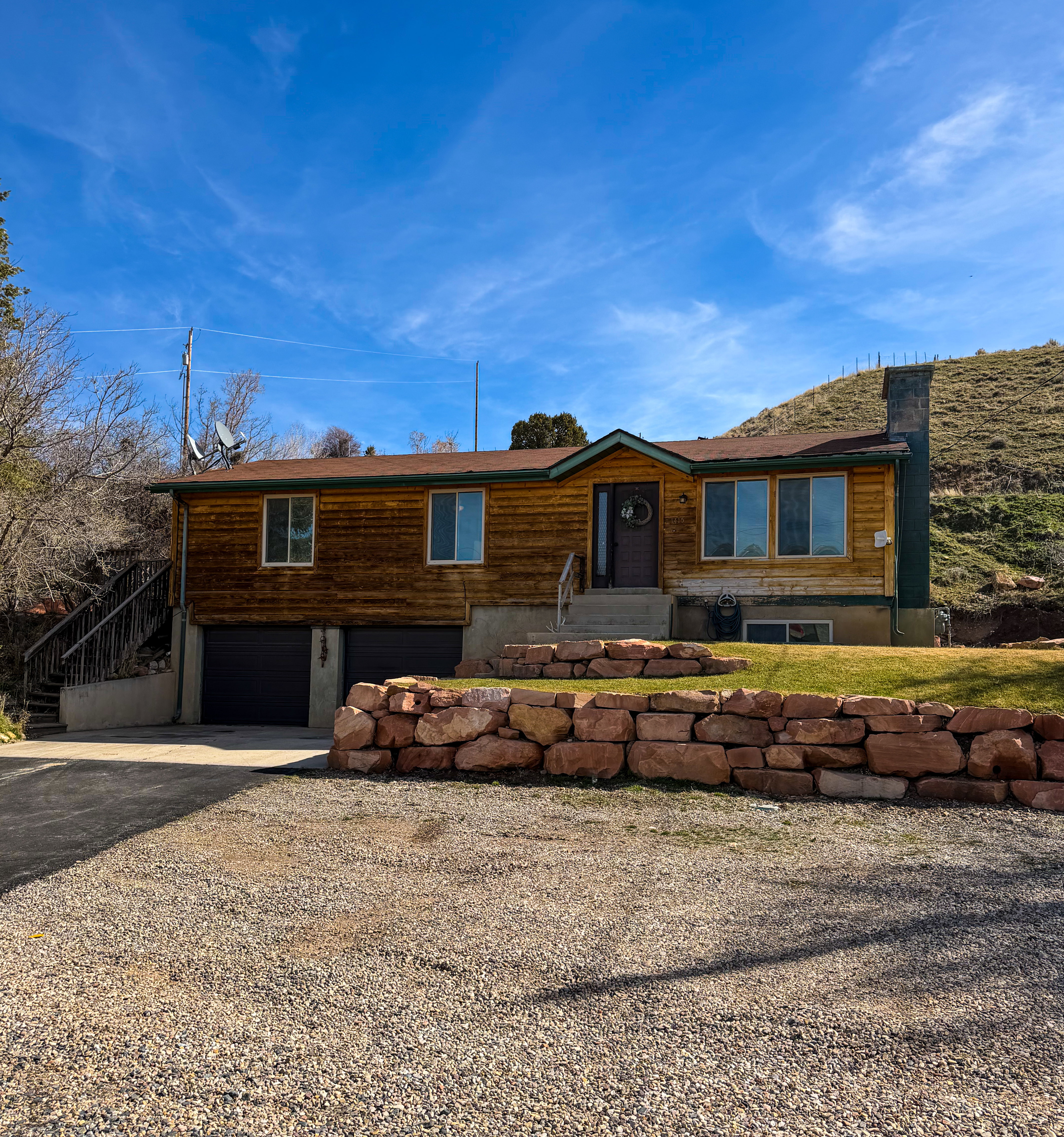 View of front of property with driveway and an attached garage