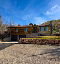 View of front of property with driveway and an attached garage