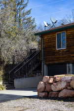 View of home's exterior with a garage and a deck