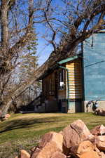 View of property exterior with a yard