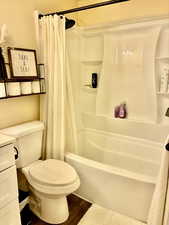 Full bath featuring vanity, wood finished floors, and shower / tub combo
