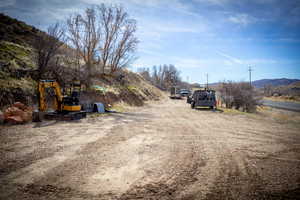 View of dirt / gravel parking lot featuring a mountain view