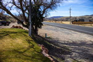 View of parking and asphalt street featuring a mountain view