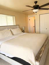 Master bedroom featuring ceiling fan and a closet