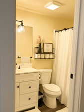 Bathroom with vanity, curtained shower, and wood-style flooring