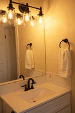 Master bathroom with vanity and decorative backsplash