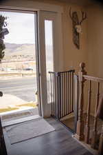 Doorway to outside featuring a mountain view and wood finished floors