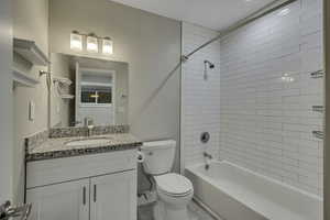 Bathroom with vanity and shower / washtub combination