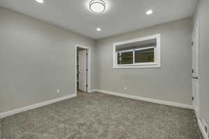 Empty room featuring light carpet and recessed lighting