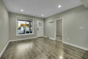 Entryway with light wood-type flooring and recessed lighting
