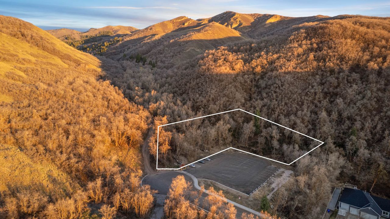 Aerial overview of property's location featuring property parcel outlined and a mountainous background