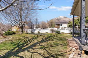 Fenced backyard with a patio and a deck with mountain view