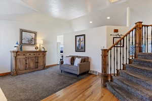 Living area featuring light wood-style floors and lofted ceiling